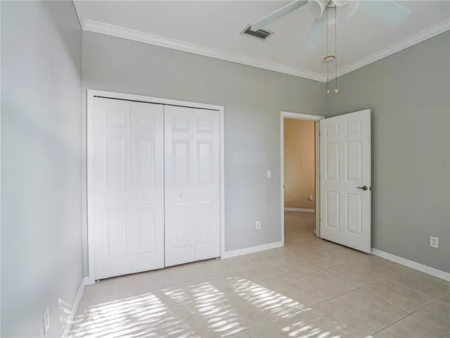 a view of a livingroom with an empty space and a ceiling fan