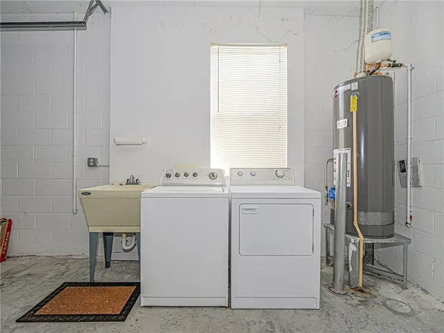 a utility room with closet dryer and washer