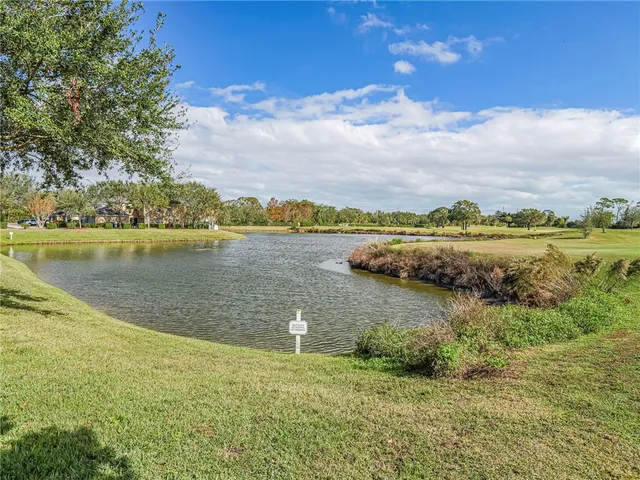 a view of a lake with houses in the back