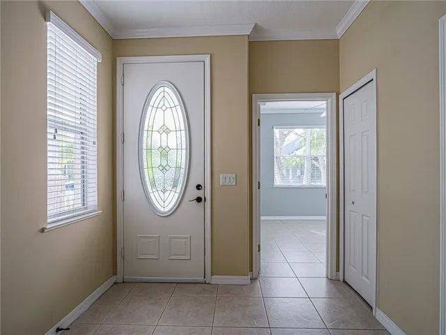 an empty room with a window and mirror