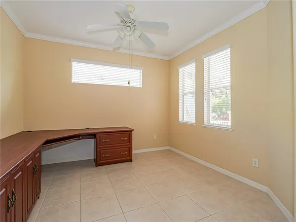 a room with a window and a chandelier