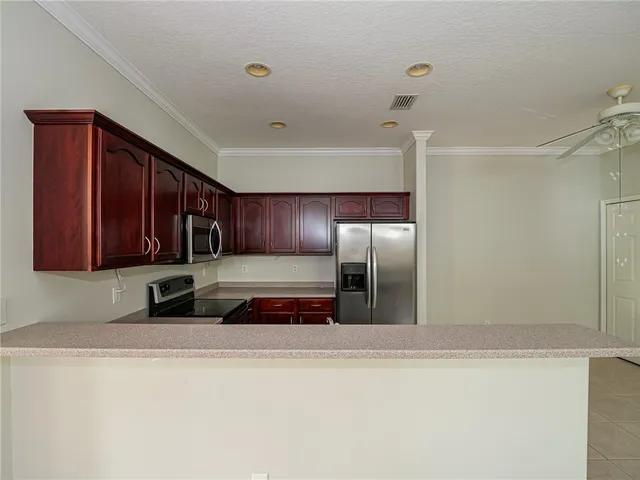 a kitchen with stainless steel appliances granite countertop a refrigerator and a sink