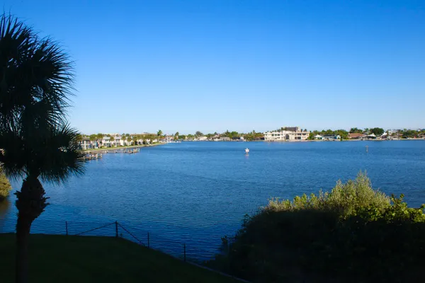 a view of a lake and houses in the back