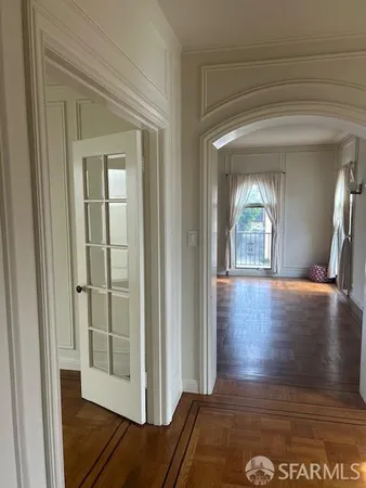 a view of a hallway with wooden floor