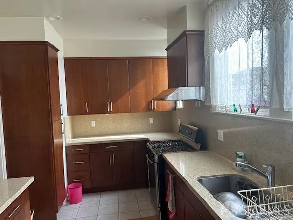 a kitchen a sink a refrigerator and window