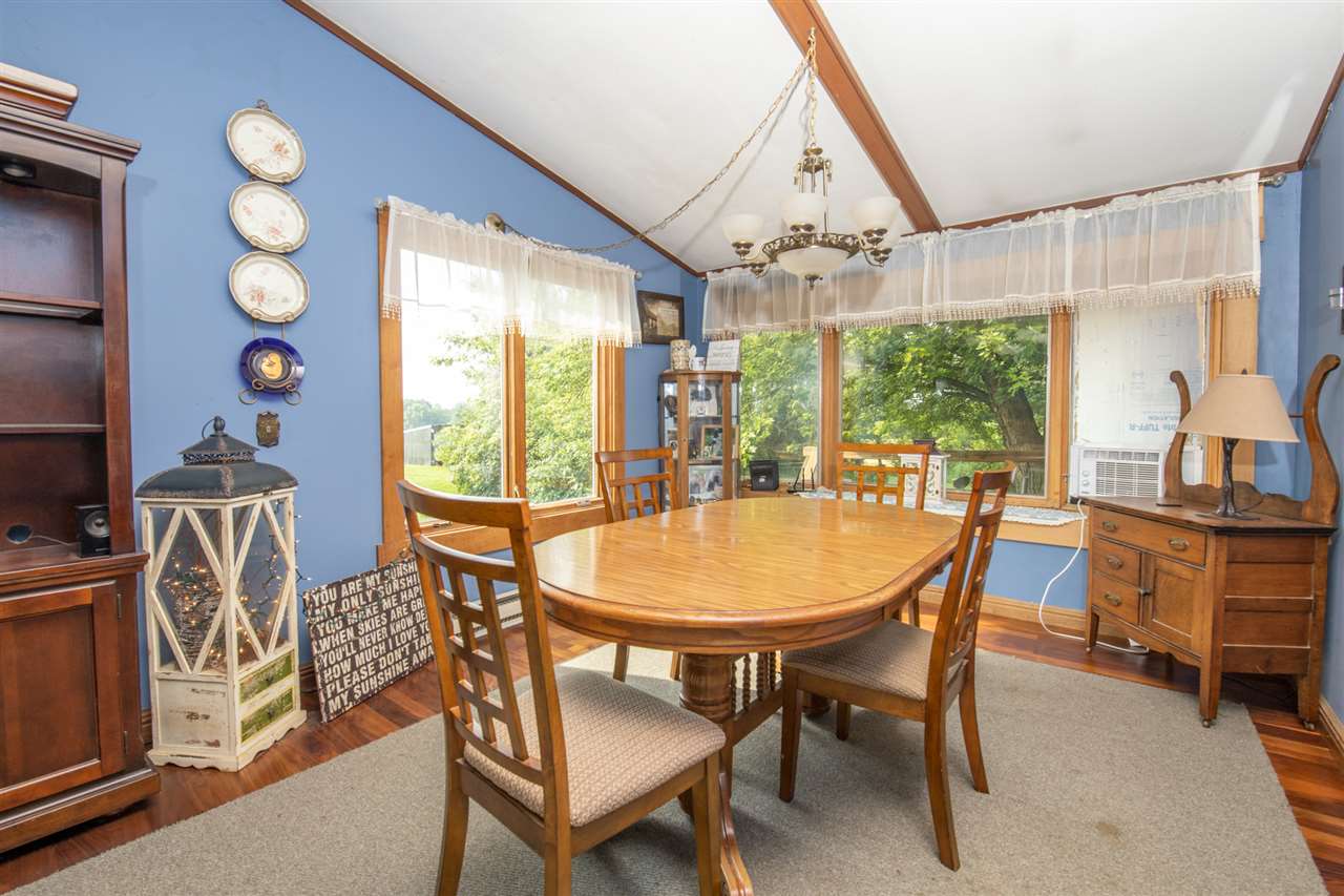 18450 East State Line Road Davis, IL 61019 - Photo 11 of 26 a dining room with furniture a chandelier and wooden floor