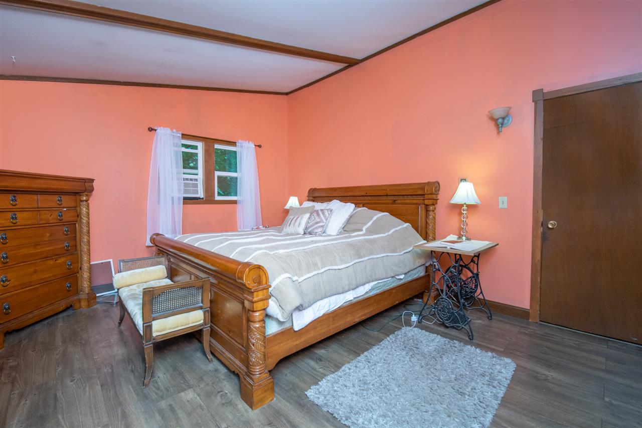 18450 East State Line Road Davis, IL 61019 - Photo 15 of 26 a bedroom with a bed and wooden floor