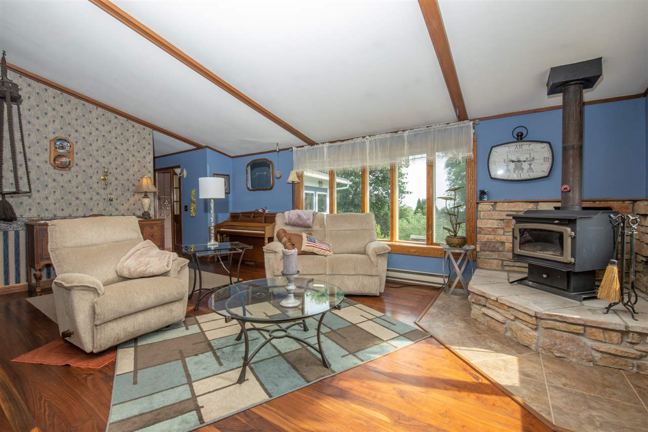 18450 East State Line Road Davis, IL 61019 - Photo 8 of 26 a living room with furniture a fireplace and a large window