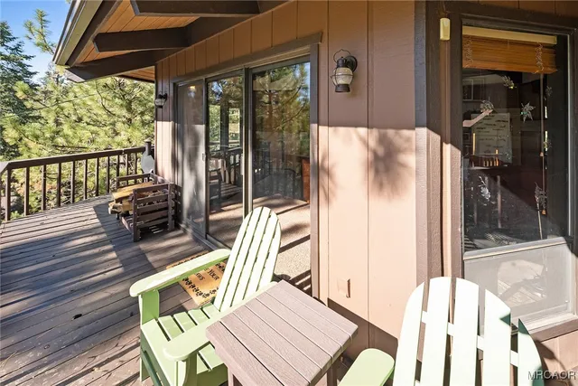 a view of balcony with wooden floor and outdoor seating