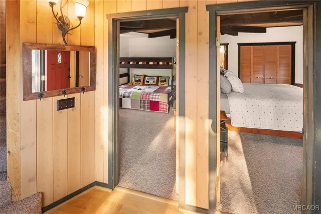 a bedroom with a bed a dresser next to a window