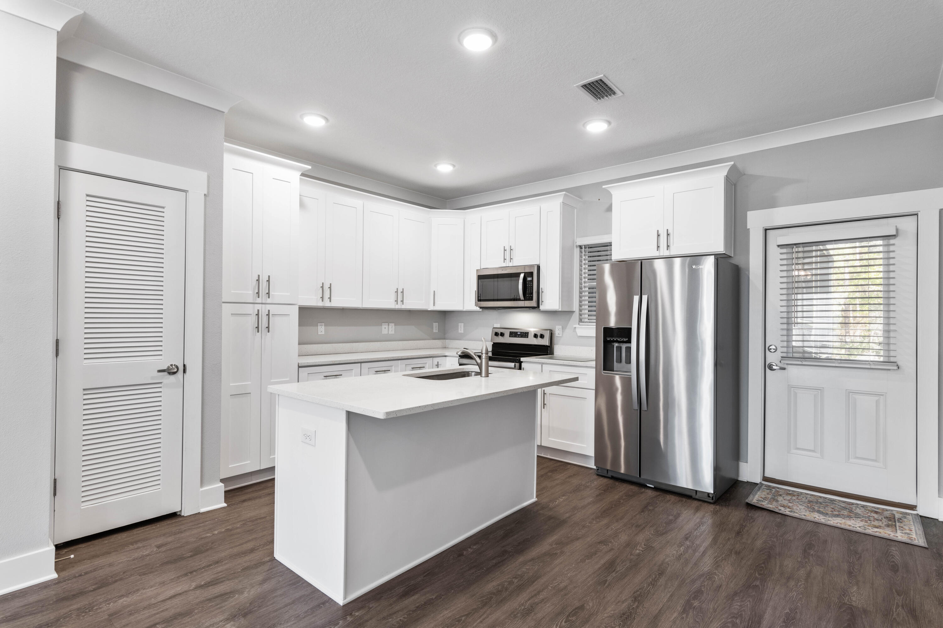296 North Sand Palm Road Freeport, FL 32439 - Photo 8 of 30 a kitchen with stainless steel appliances a refrigerator and a stove top oven