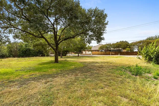 a view of yard with swimming pool and trees