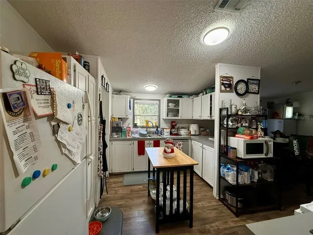 a kitchen with a refrigerator and a stove