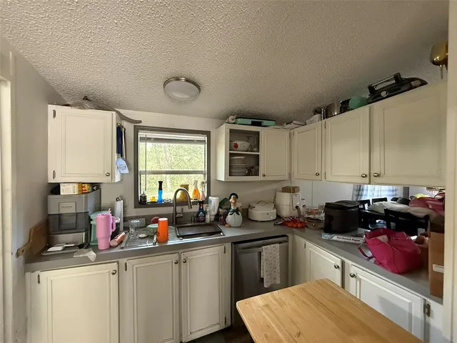 a kitchen with stainless steel appliances white cabinets and a stove
