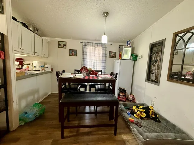 a view of a workspace with furniture and wooden floor