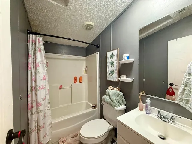 a bedroom with a bed cabinets and a window