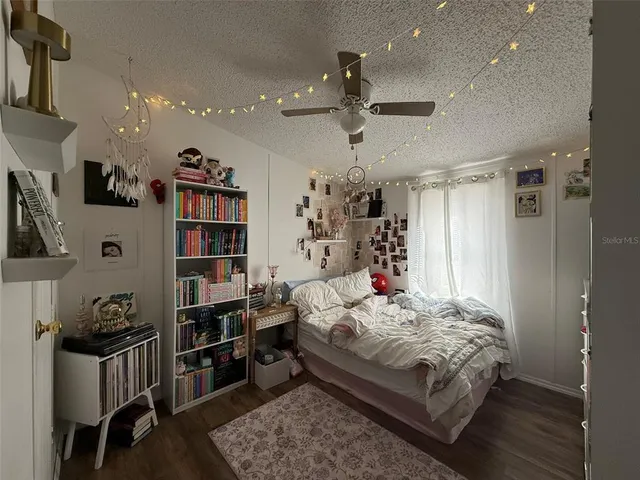 a room with furniture a large window and a potted plant