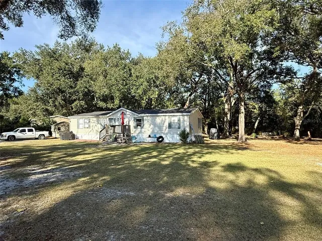 a view of swimming pool with outdoor seating and yard