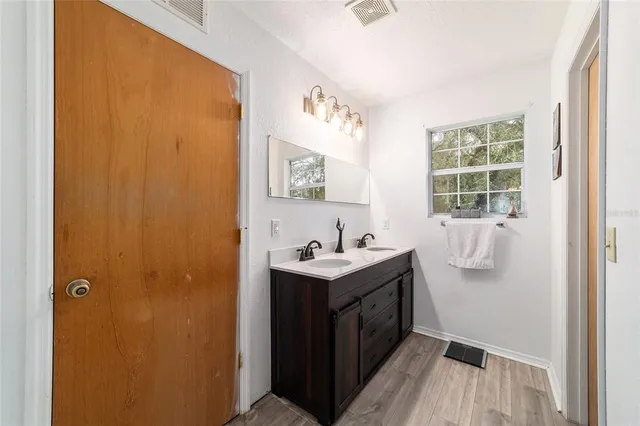 a view of a house with a yard and sitting area