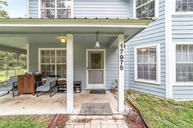 a view of a house with a yard and sitting area