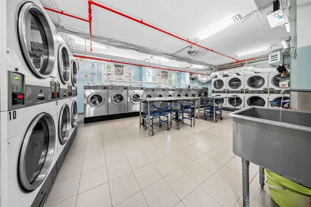 a view of a storage and utility room with washer and dryer