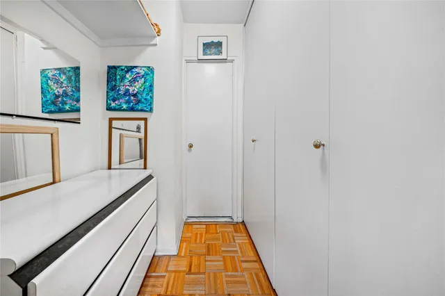 a bed room with a bed and painting on the wall