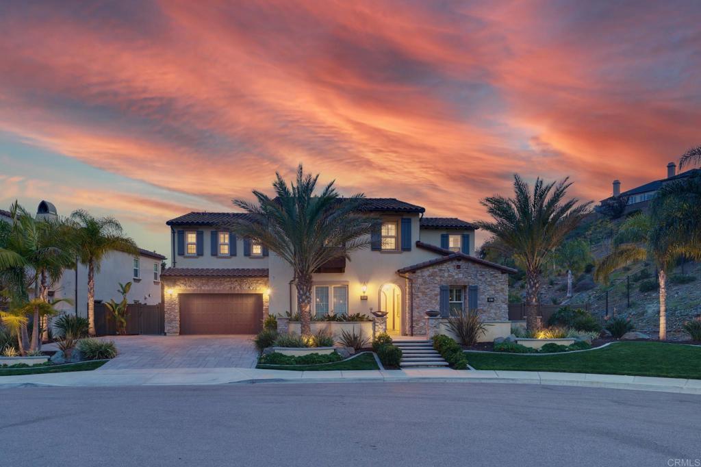 a front view of a house with a garden and a garage