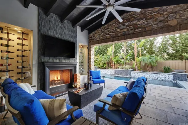 a living room with furniture a flat screen tv and a fireplace