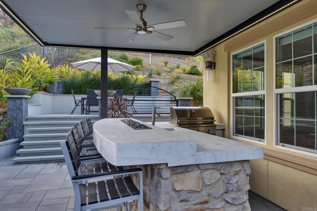 3615 Corte Claro Carlsbad, CA 92009 - Photo 24 of 49 a view of a patio with a table chairs and a potted plant