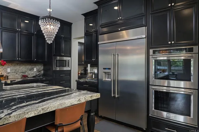 a kitchen with a refrigerator and microwave
