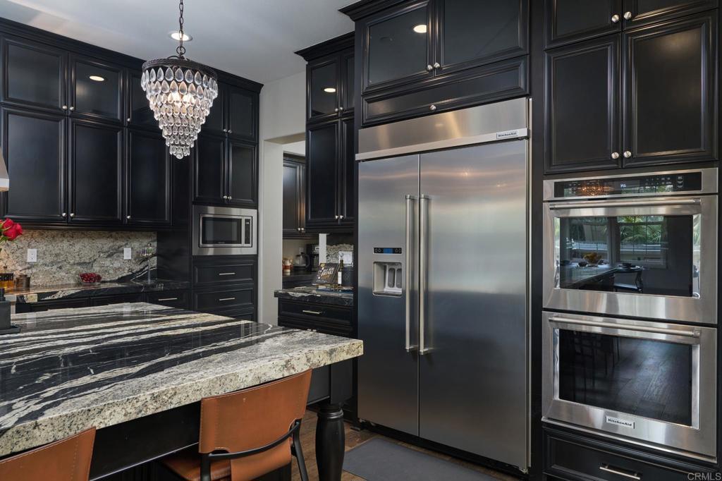 3615 Corte Claro Carlsbad, CA 92009 - Photo 27 of 49 a kitchen with a refrigerator and microwave
