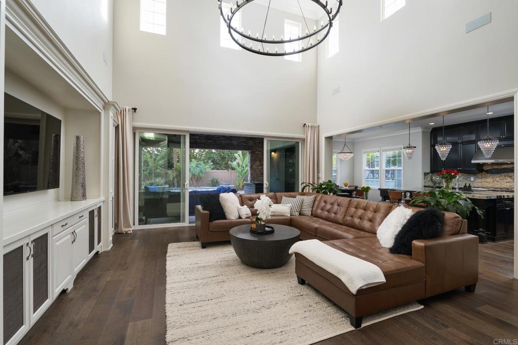 3615 Corte Claro Carlsbad, CA 92009 - Photo 29 of 49 a living room with furniture a flat screen tv and a large window