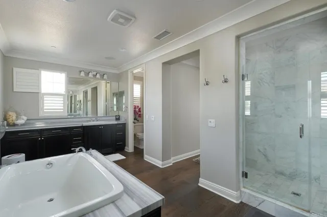 a spacious bathroom with a bathtub sink and shower
