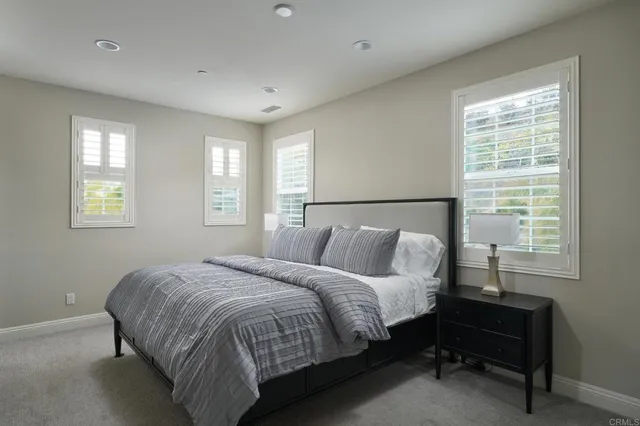 a bed sitting in a bedroom next to a window
