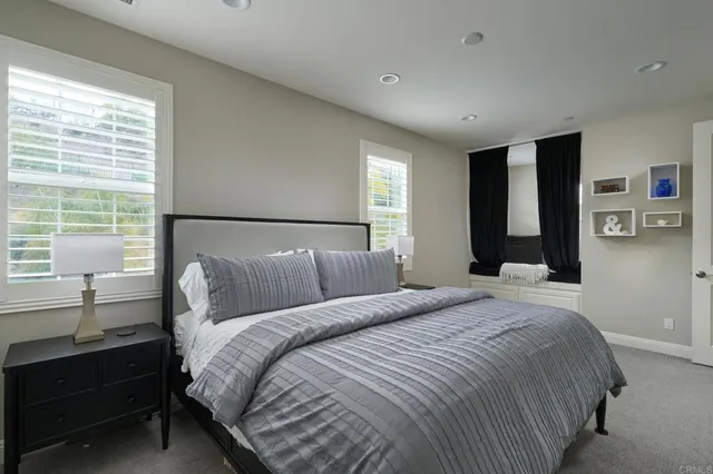 a bedroom with a bed and a lamp