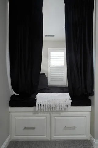 a view of closet with wooden floor