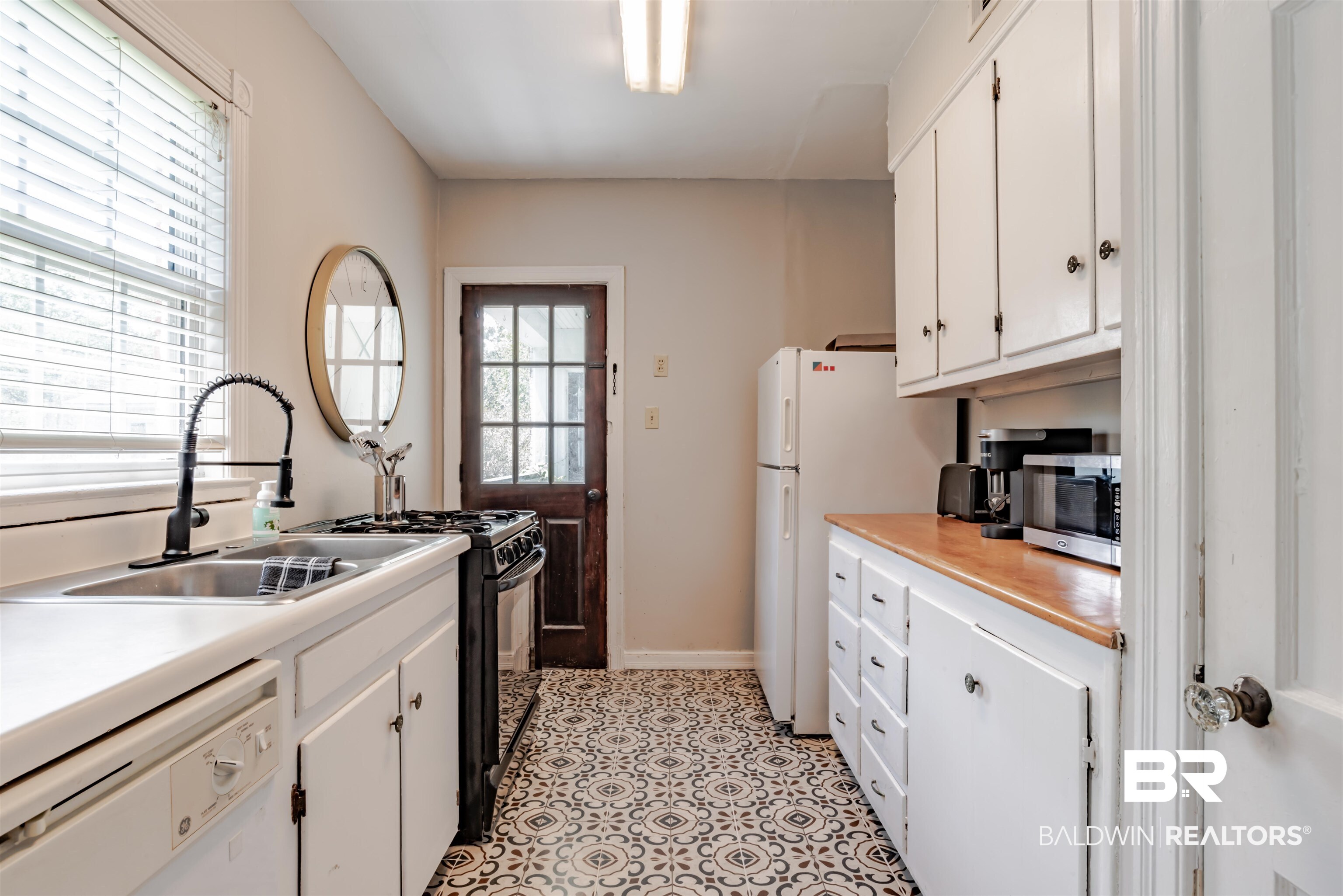 214 Upham Street, Unit 7C Mobile, AL 36607 - Photo 10 of 32 Kitchen featuring white cabinetry, white appliances, and light countertops