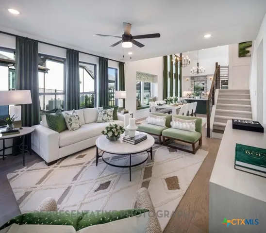 a living room with fireplace furniture and a large window