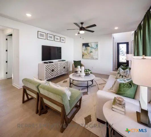 a living room with furniture and a flat screen tv