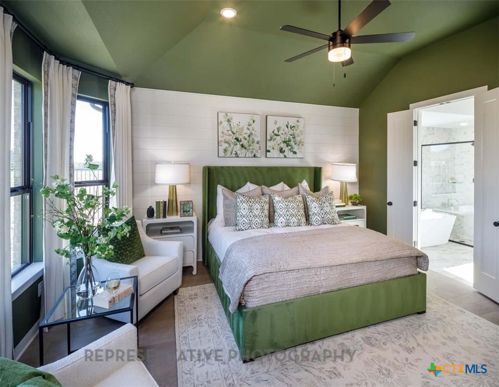 133 Three Oaks Lane Georgetown, TX 78628 - Photo 16 of 40 a spacious bedroom with a bed chandelier and a window
