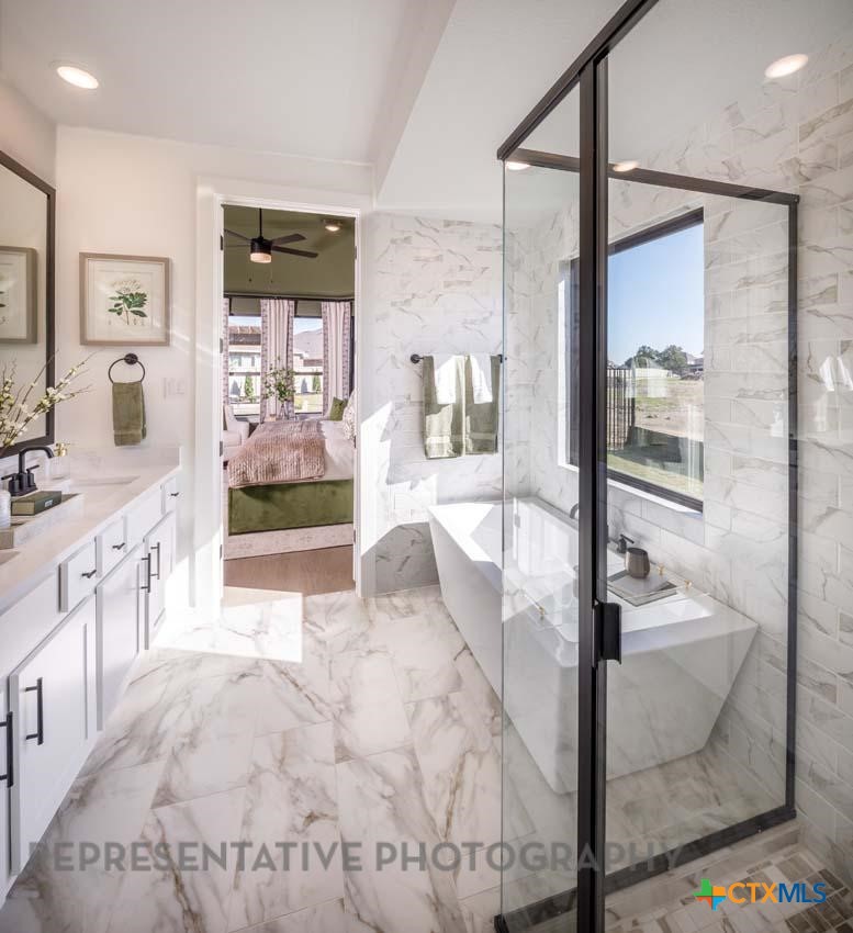133 Three Oaks Lane Georgetown, TX 78628 - Photo 19 of 40 a spacious bathroom with a tub and shower