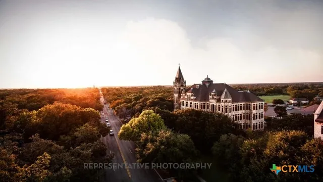a front view of a residential apartment building with a yard