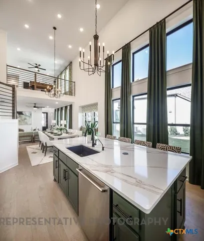 a kitchen with stainless steel appliances granite countertop a sink a stove and a refrigerator