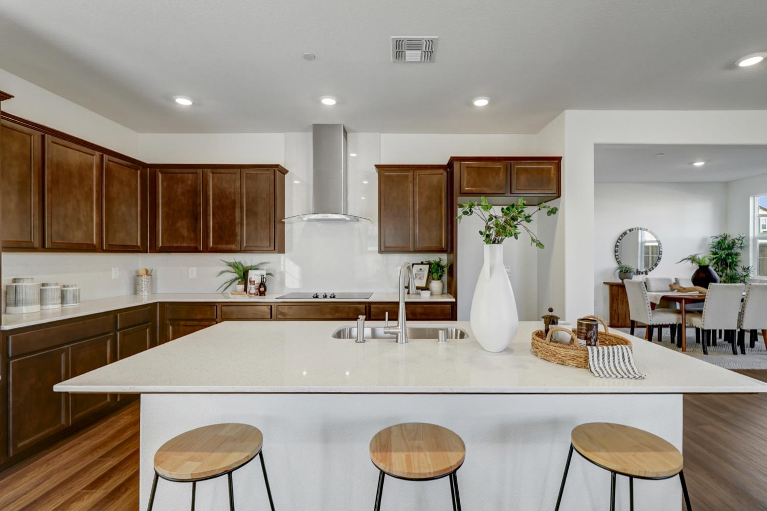 10167 Ramy Circle Elk Grove, CA 95757 - Photo 13 of 50 a kitchen with stainless steel appliances granite countertop a sink a stove a refrigerator white cabinets and chairs