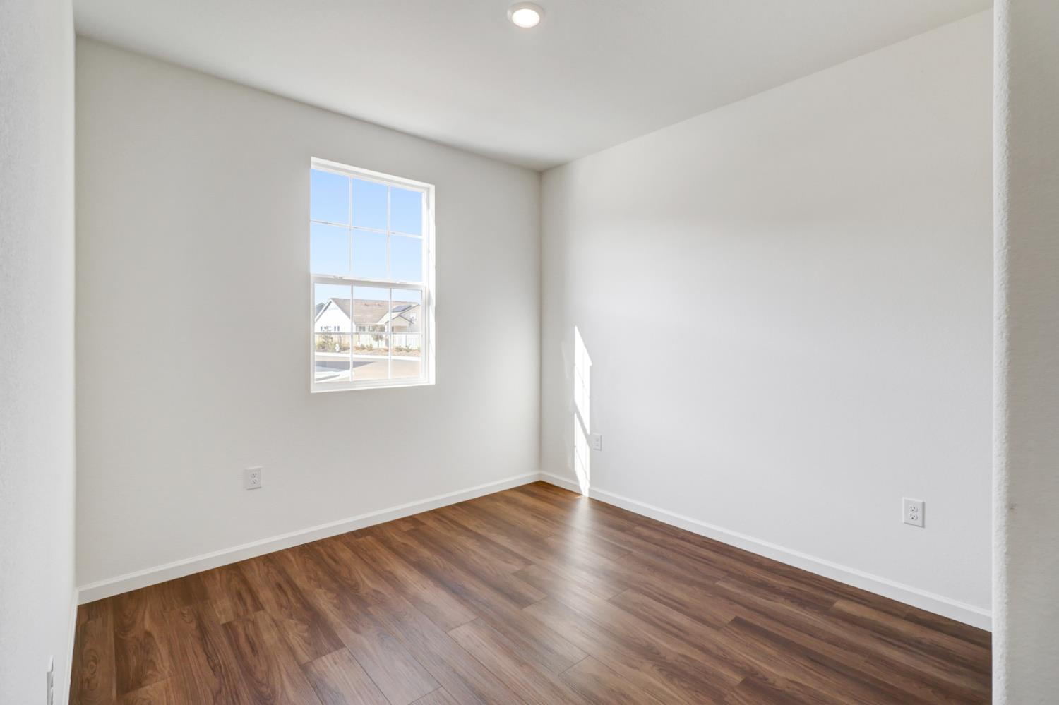 10167 Ramy Circle Elk Grove, CA 95757 - Photo 36 of 50 an empty room with wooden floor and windows