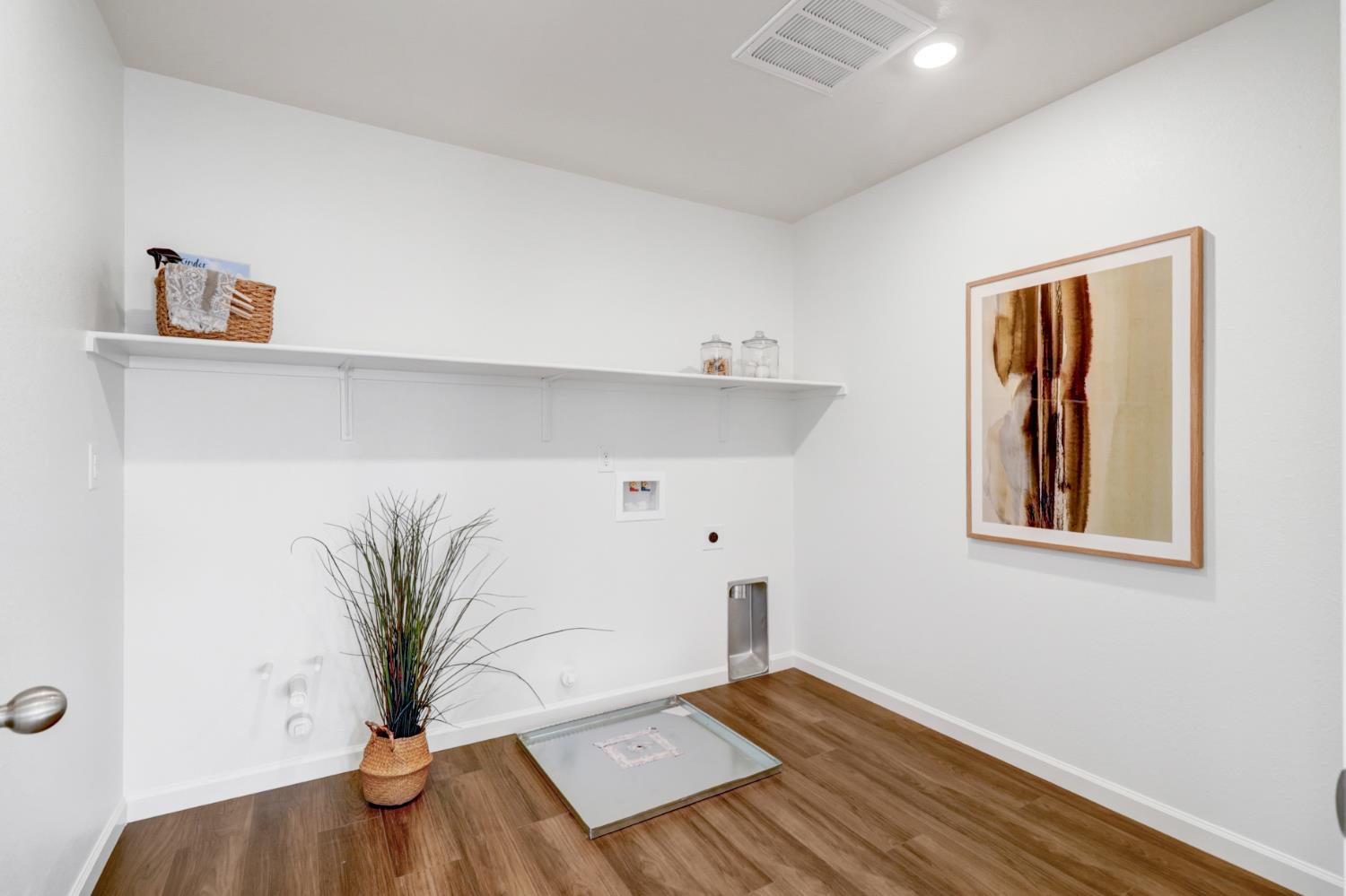10167 Ramy Circle Elk Grove, CA 95757 - Photo 41 of 50 a view of an empty room with potted plant and wooden floor