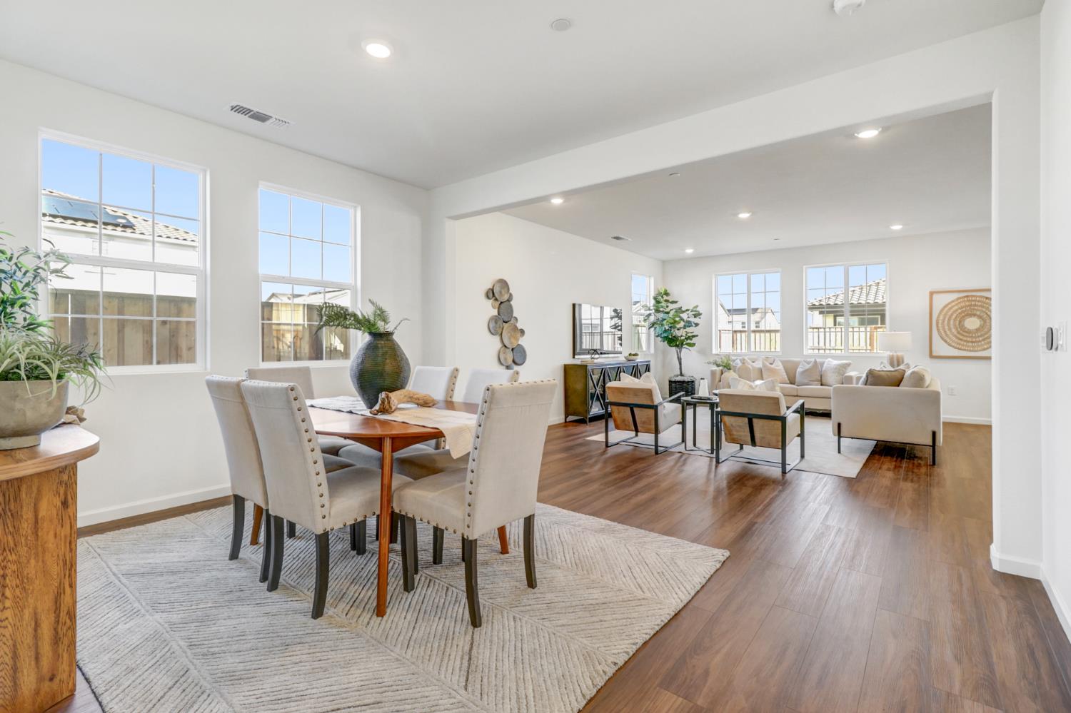 10167 Ramy Circle Elk Grove, CA 95757 - Photo 5 of 50 a dining room with furniture wooden floor and a floor to ceiling window