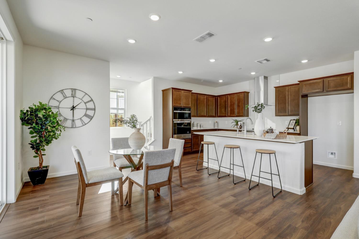 10167 Ramy Circle Elk Grove, CA 95757 - Photo 10 of 50 a kitchen with stainless steel appliances granite countertop a kitchen island hardwood floor sink and stove