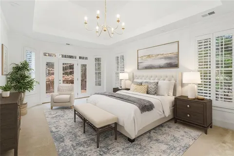 a spacious bedroom with a bed and a large window