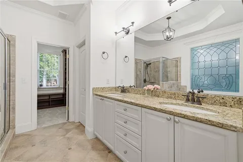 a bathroom with a granite countertop sink mirror and double